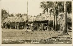 an old black and white photo of some huts