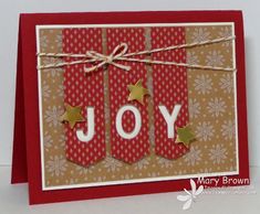 a christmas card with the word joy on it and two gold stars tied to each other