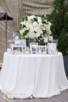 a table with pictures and flowers on it