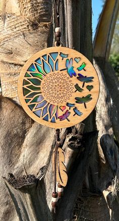 a wooden sun catcher hanging from a tree