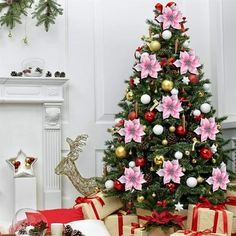 a christmas tree decorated with pink flowers and red bows, surrounded by presents on the floor