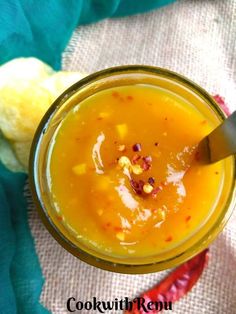 a close up of a glass with food in it and a spoon on the side