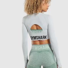 Gymshark Nwot Flexpress Yourself Xxl Long Sleeve Crop Top . Made Wth Seamless, Sweat Wicking Fabric That Will Move With You Through Even Your Toughest Workout. The Body Contouring Silhouette, Cut Out And Bold Logo Give You A Base Piece Perfect For Creating Your Own Look. This Brand Runs Small , Please Go By Measurements If Purchasing Gymshark For The First Time. Pit To Pit 16 1/2" Length 16 1/2" Waist 15" Cropped Fit Round Neckline Long Sleeves Thumb Holes To Cuffs Body Contouring Sweat Wicking Gymshark Women, Bold Logo, Training Tops, Top Light, Body Contouring, Long Sleeve Crop, Silhouette Cut, Thumb Holes, Grey Long Sleeve