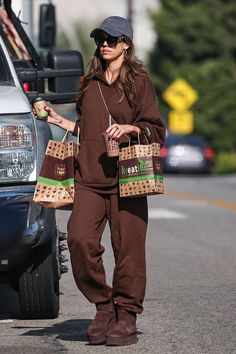 a woman walking down the street carrying shopping bags