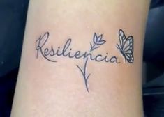 a tattoo with the word resilicia written in cursive writing