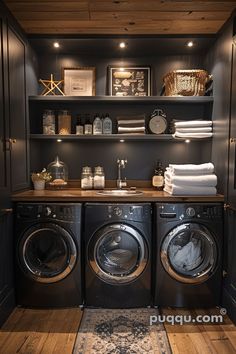 a washer and dryer in a room with dark wood floors, built - in shelving