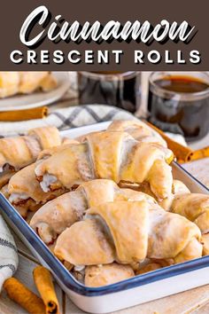 cinnamon crescent rolls in a baking pan on a wooden table with the words cinnamon crescent rolls