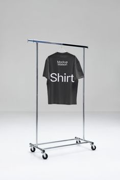 a t - shirt is hanging on a metal rack