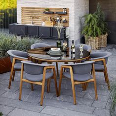 an outdoor dining table with six chairs around it