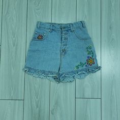 Femme Fatale Vintage 1990s Denim Shorts With Floral Embroidery Vintage Floral Embroidered Bottoms For Summer, Vintage Embroidered Summer Bottoms, Retro Embroidered Bottoms For Spring, Vintage Embroidered Denim Blue Bottoms, Embroidered Medium Wash Denim Jean Shorts, Retro Embroidered Denim Bottoms, Embroidered Medium Wash Denim Shorts, Embroidered Denim Blue Jean Shorts, Embroidered Medium Wash Cotton Jean Shorts