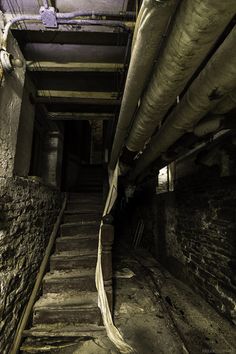 an old building with stairs leading up to the top floor and another room on the second floor