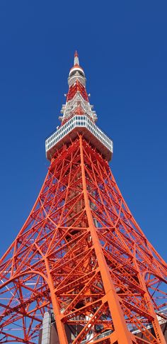 an orange tower with a white top against a blue sky