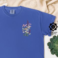 Comfort Colors Flower Embroidered Shirt, Floral Tee, Floral Sweatshirt, Flower T-shirt, Wild Flower sweatshirt, Wildflower Tee, Gift for her This listing is for an embroidered shirt, making it a luxurious choice. Embroidery adds a premium, tactile quality to your item, offering a more refined and durable finish compared to other methods. Explore more fun and unique designs at https://www.etsy.com/shop/iconiquecrafts/ SHIPPING TO HAWAII OR ALASKA Please contact us before ordering if you live in A Blue T-shirt With Embroidered Text For Spring, Cotton Floral Embroidery Short Sleeve Shirt, Cotton Short Sleeve Shirt With Floral Embroidery, Floral Embroidered Cotton Short Sleeve Shirt, Spring Long Sleeve T-shirt With Embroidered Graphics, Blue Tops With Embroidered Text For Spring, Blue Embroidered Relaxed Fit T-shirt, Blue Cotton Shirt With Floral Embroidery, Casual Crew Neck Shirt With Machine Embroidery