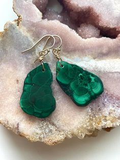 Enchant her with these gorgeous green malachite earrings, a gift she will never forget!  luscious velvet green malachite stone has been polished into a beautiful pendent and drilled to perfection to create these magical earrings! Great gift for someone special in your life or to yourself.  Gold filled metal  ✨1 3/4" drop length  ✨You will receive the pair pictured  ✨Gold filled  ✨Your earrings  will come in a velvet jewelry bag  Malachite, with its beautiful, rich green color, leaves no doubt of Handmade Green Malachite Jewelry, Green Natural Stones Drop Earrings, Green Natural Stone Drop Earrings, Green Earrings With Natural Stones As Gift, Green Malachite Gemstone Jewelry, Dark Green Drop Earrings As Gift, Dark Green Drop Earrings For Gift, Magical Earrings, Green Stone Earrings