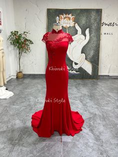 a red evening gown on display in a store