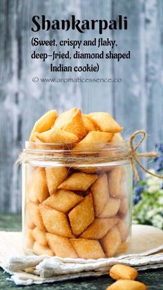 a glass jar filled with cookies sitting on top of a table