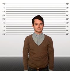 a man is standing in front of a mug shot