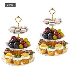 two tiered trays filled with cupcakes, muffins and fruit