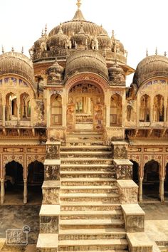 an ornate building with steps leading up to the top and bottom levels, in india