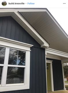 a black house with white trim and windows