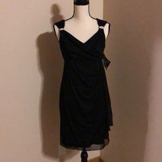 Black Dress, V Neck Bodice, Full Back Zipper, Sleeveless, Accented Front. Elegant Sleeveless Dress For Holiday Night Out, Fitted Sleeveless Dress For Evening Holiday, Fitted Sleeveless Dress For Holiday Evenings, Black Sleeveless Sequin Dress For Evening, Glamorous Black Sleeveless Dress For Party Season, Black Sequined Sleeveless Dress For Evening, Sleeveless Evening Dress For Dinner Parties, Black Sleeveless Evening Dress For Holiday, Sleeveless Evening Dress For Prom Season Dinner