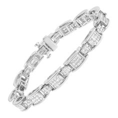 A must have for any serious jewelry collection, this stunning 14K white gold tennis bracelet boasts an impressive 5.0 carat total weight of diamonds. The bracelet features D or bridge shaped links that alternate between large and small sizes both inset with invisible set grids of square, princess cut white diamonds. Each diamond studded link is connected by hinges. Elegant and timeless, this gorgeous 7” tennis bracelet fastens securely with a box with tongue and safety clasp. This classic, bold Diamonds Bracelet, Diamond Earrings Design, Geometrical Design, Bracelet Tennis, Modern Bracelets, Earrings Design, White Gold Bracelet, Princess Diamond, Bracelet Clasps