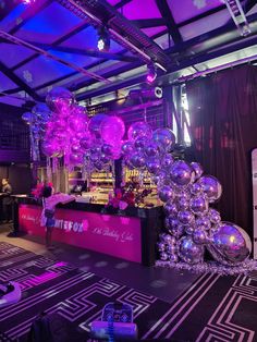 the bar is decorated with purple and silver balloons