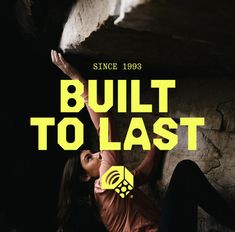 a woman leaning up against a rock with the words built to last above her head