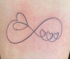 a tattoo on the back of a woman's shoulder with hearts and an infinite love sign