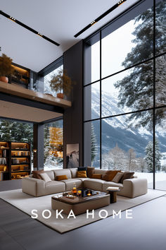 a modern living room with large windows overlooking the mountains