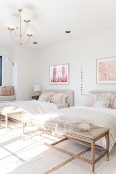 a bedroom with two beds and a chandelier