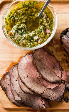 sliced roast beef on cutting board with salsa in bowl