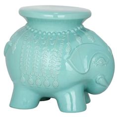 an elephant shaped glass vase sitting on top of a table