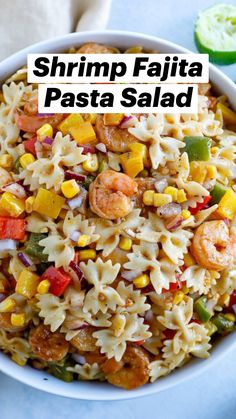 a white bowl filled with pasta salad and shrimp