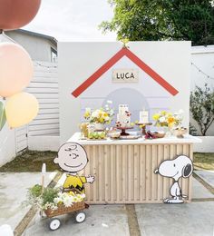 a charlie the snoopy birthday party with balloons and decorations on display in front of a house