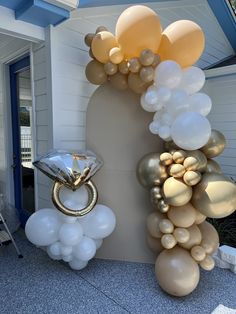 balloons and rings are hanging from the side of a wall in front of a house