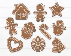 gingerbread cutouts are arranged on a white background with snowflakes and christmas decorations