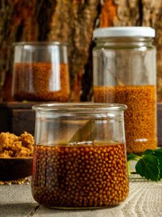 three jars filled with food sitting on top of a table