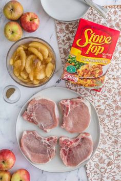 the ingredients to make apple cider are laid out on a marble counter top, including apples and pork chops