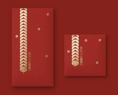 two pieces of red paper with gold thread on them