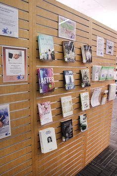 there are many books on the wall in this office building that is decorated with wood slats