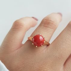 RING DETAILS: ✪Design: Gold ring ✪Gemstone: Natural coral ✪Gemstone color: Red ✪Gemstone size: 9mm Gemstone weight: 2.15mm ✪Gemstone shape: Round ✪Setting type: Prong Gold weight: 2 gram ✪Metal type: 14k solid yellow gold ✪Metal finish: Smooth shiny Choose your ring size from drop down menu and if you need any other preferred ring size please contact us. QUALITY OF MATERIALS: Metal: Most of our jewelry at JewelryMansion is made with precious metals like gold and silver. These metals are 100% non Elegant Red Crystal Round Ring, Elegant Red Round Crystal Ring, Red Cabochon Ruby Ring In 14k Gold, 14k Gold Red Cabochon Ruby Ring, Red Jewelry With Round Stone In Prong Setting, Red Birthstone Ring With Round Stone For Gift, Red Round Jewelry With Prong Setting, Red Rings With Prong Setting, Red Ring With Prong Setting