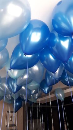 blue and silver balloons are floating in the air