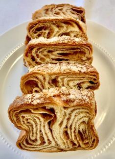 three pieces of pastry sitting on top of a white plate