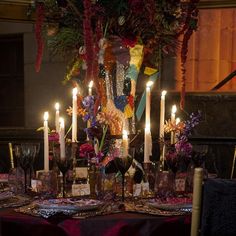 a table topped with lots of candles and flowers