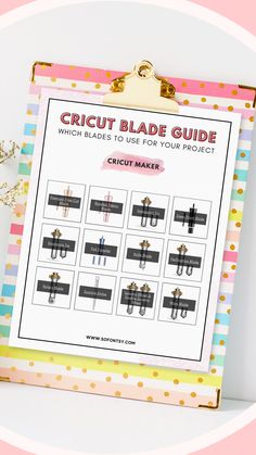 the circuit blade guide is hanging on a clipboard next to some flowers and other items