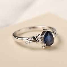 a close up of a ring with a blue stone