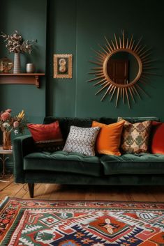 a living room with green walls and lots of colorful pillows on the couch, along with a sunburst