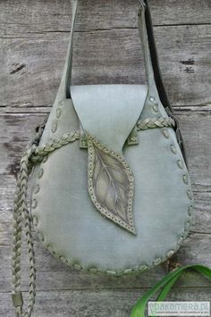 a purse with a leaf on the front