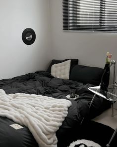 a black and white bedroom with a large bed